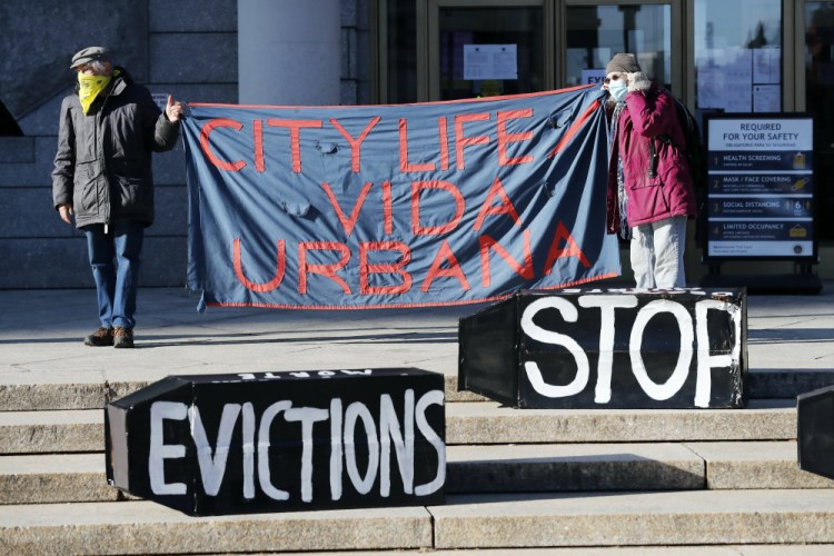 Tenants' rights advocates demonstrate in front of the Edward W. Brooke Courthouse in Boston in January. The Biden administration is extending through June a federal moratorium on evictions of tenants who've fallen behind on rent during the coronavirus pandemic. 
