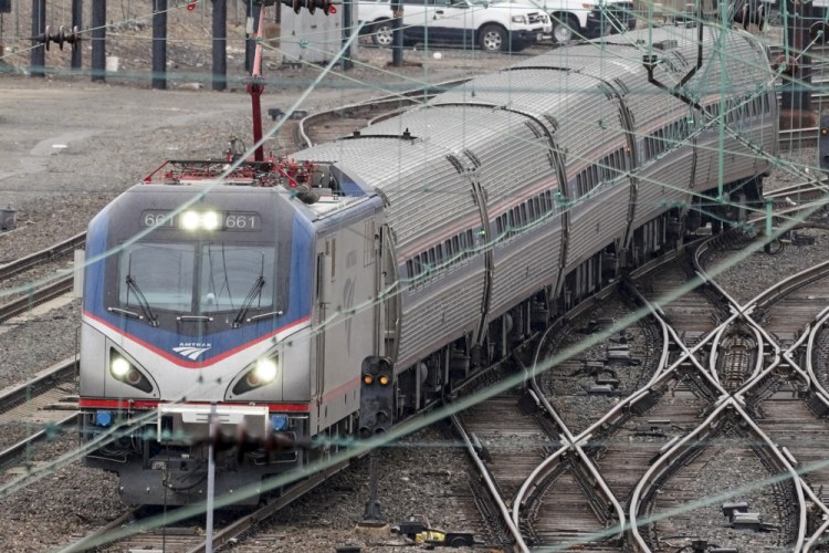 An Amtrak train departs 30th Street Station in Philadelphia on Wednesday. President  Biden and lawmakers are laying the groundwork for another of his top legislative priorities – a long-sought boost to the nation's roads, bridges and other infrastructure that could meet Republican resistance to a hefty price tag. 