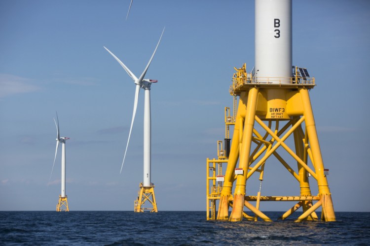 Three wind turbines stand in the water off Block Island, R.I., in 2016. 