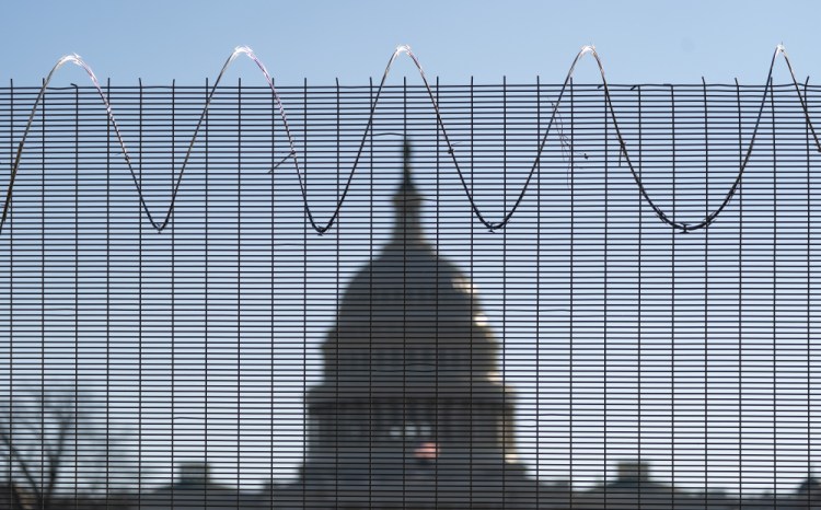 Fencing and razor wire surround the perimeter of the U.S. Capitol in Washington last month.  Acting Capitol Police chief Yogananda Pittman said her investigators had collected “some concerning intelligence” about a possible plot to try to breach the Capitol again on Thursday.