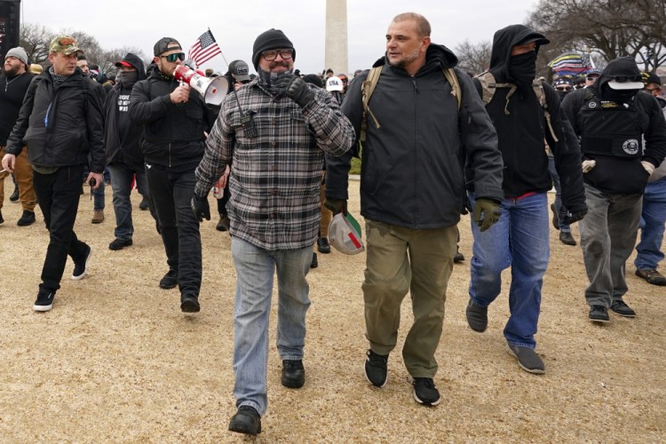 In this Jan. 6, 2021, photo, Proud Boys including Joseph Biggs, front left, walks toward the U.S. Capitol in Washington, in support of President Donald Trump. 