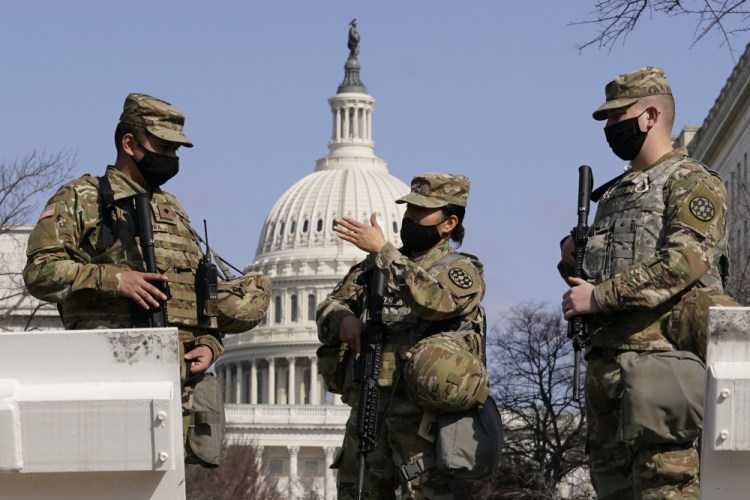 Members of the National Guard stand guard at the Capitol in Washington on Thursday.
