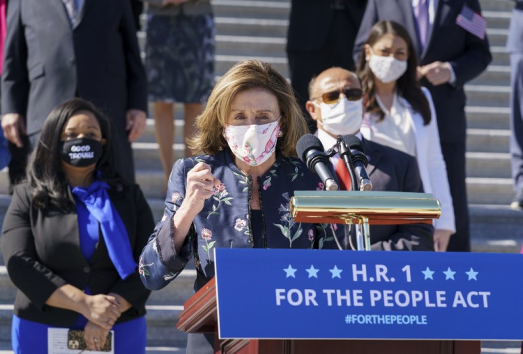 Speaker of the House Nancy Pelosi, D-Calif., and the Democratic Caucus gather to address reporters on H.R. 1, the For the People Act of 2021, at the Capitol in Washington on Wednesday. House Democrats are expected to pass the sweeping elections and ethics bill. 