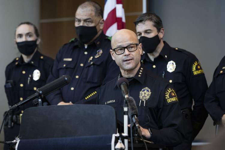 Chief Eddie García, center, speaks with media during a press conference regarding the arrest and capital murder charges against Officer Bryan Riser at the Dallas Police Department headquarters on Thursday in Dallas. 