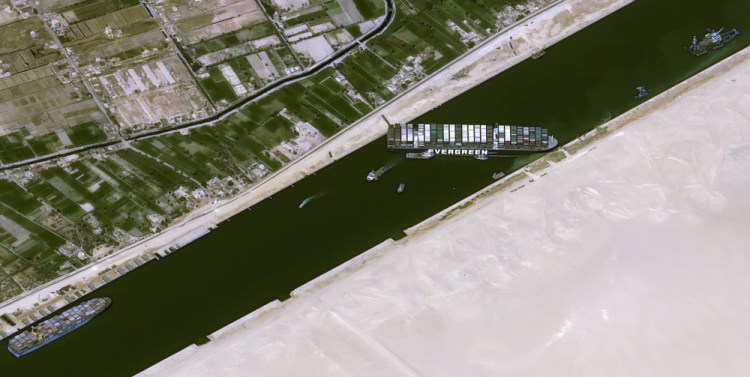 This satellite image shows the cargo ship MV Ever Given stuck in the Suez Canal near Suez, Egypt, on Thursday. The skyscraper-size cargo ship wedged across Egypt's Suez Canal further imperiled global shipping Thursday as at least 150 other vessels needing to pass through the crucial waterway idled waiting for the obstruction to clear, authorities said. 