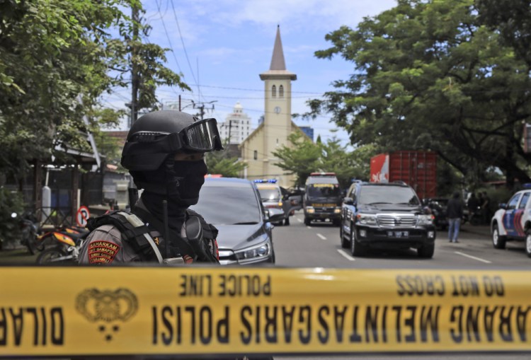 A police officer stands guard near Sacred Heart of Jesus Cathedral in Makassar, South Sulawesi, Indonesia, on Sunday. 