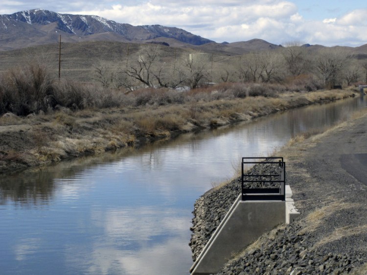 Water flows through an irrigation canal in Fernley, Nev., about 30 miles east of Reno on Thursday.