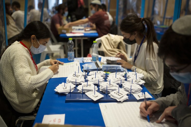Workers count votes in Israel's national elections, at the Knesset in Jerusalem on Thursday. 