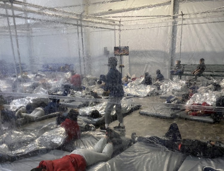 This March 20, 2021, photo provided by the Office of Rep. Henry Cuellar, D-Texas, shows detainees in a Customs and Border Protection (CBP) temporary overflow facility in Donna, Texas. 