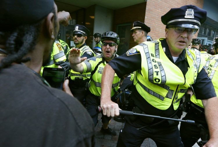 Counterprotesters clash with police following a "Free Speech" rally staged by conservative activists Aug. 19, 2017, in Boston. Boston's police department remains largely white in 2021, despite vows for years by city leaders to work toward making the police force look more like the community it serves.