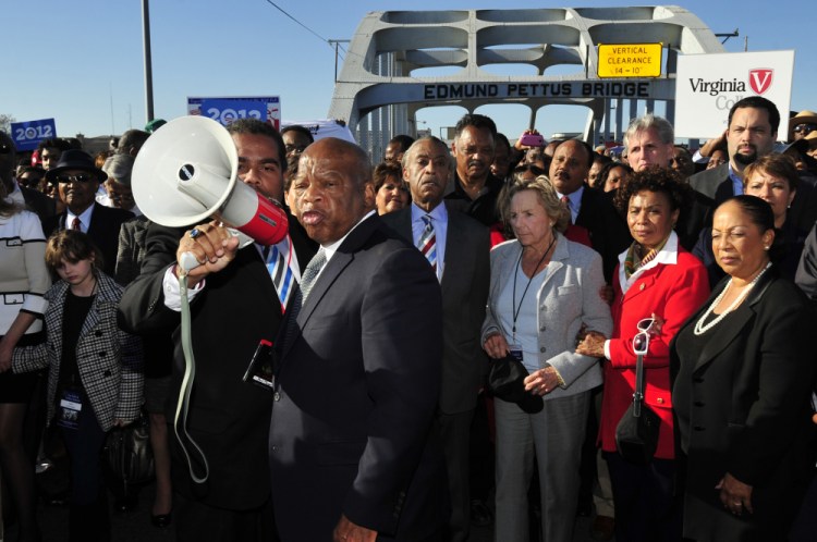 U.S. Rep. John Lewis, D-Ga., center, talks with those gathered on the historic Edmund Pettus Bridge during the 19th annual reenactment of the "Bloody Sunday" Selma to Montgomery civil rights march across the bridge in Selma, Ala., on March 4, 2012.
