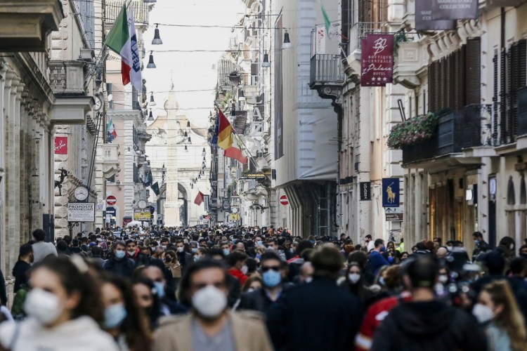 People crowd Via del Corso shopping street Feb. 7 in Rome, following the ease of restriction measures to curb the spread of COVID-19. 