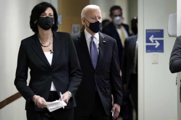 In this March 19 photo, Dr. Rochelle Walensky, director of the Centers for Disease Control and Prevention, leads President Joe Biden into the room for a COVID-19 briefing at the headquarters for the CDC Atlanta. 