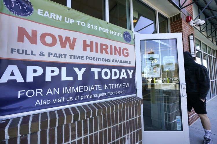 A man walks into a restaurant displaying a "Now Hiring" sign on Thursday in Salem, N.H.  U.S. employers added a robust 379,000 jobs last month, the most since October and a sign that the economy is strengthening as confirmed viral cases drop, consumers spend more and states and cities ease business restrictions. 