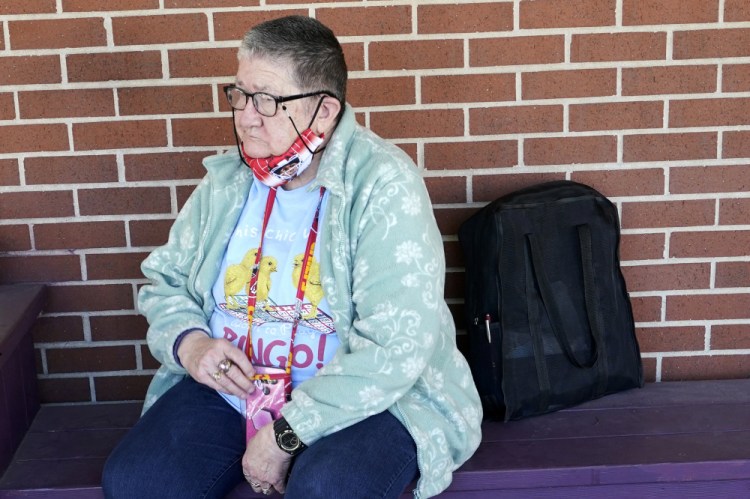 Pat Brown waits outside the Don Bosco Senior Center in Kansas City, Mo., on Wednesday. Brown knows she needs the vaccine because her asthma and diabetes put her at higher risk of serious COVID-19 complications. But Wall hasn’t attempted to schedule an appointment and didn’t even know if they were being offered in her area yet; she says she is too overwhelmed. 