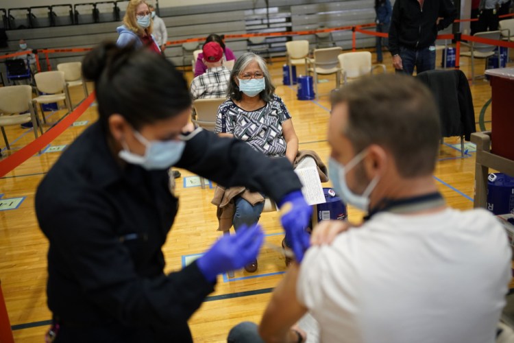 People receive the COVID-19 vaccine at a vaccination site in Las Vegas on Feb. 17. 
