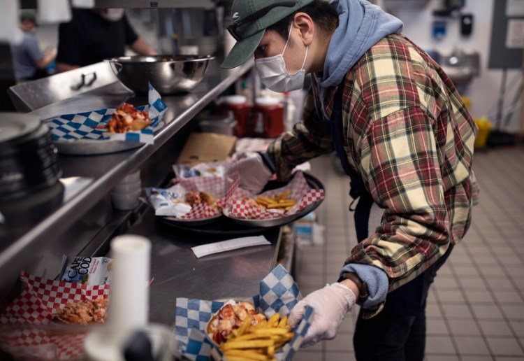 Zack Ball works as the expeditor on the line during a lunch shift at Luke’s Lobster.