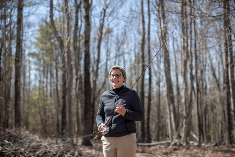 READFIELD, ME - APRIL 3: Lisa Garside poses for a portrait with her fishing rod at her home in Readfield on Saturday, April 3, 2021. Garside began fishing in June of last year and said after she caught her first fish, a 17-inch-landlocked salmon, she was hooked. (Staff photo by Brianna Soukup/Staff Photographer)
