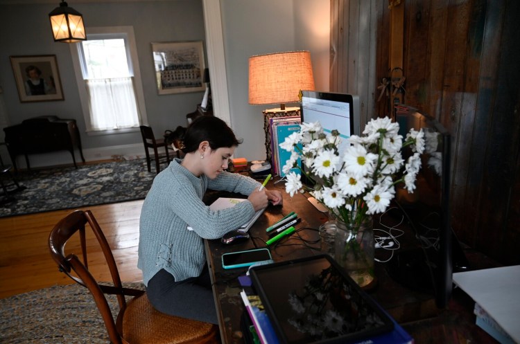 Emilia Diaz of Falmouth, a seventh-grader who enrolled in Maine Connections Academy this year, works on math homework at her home.