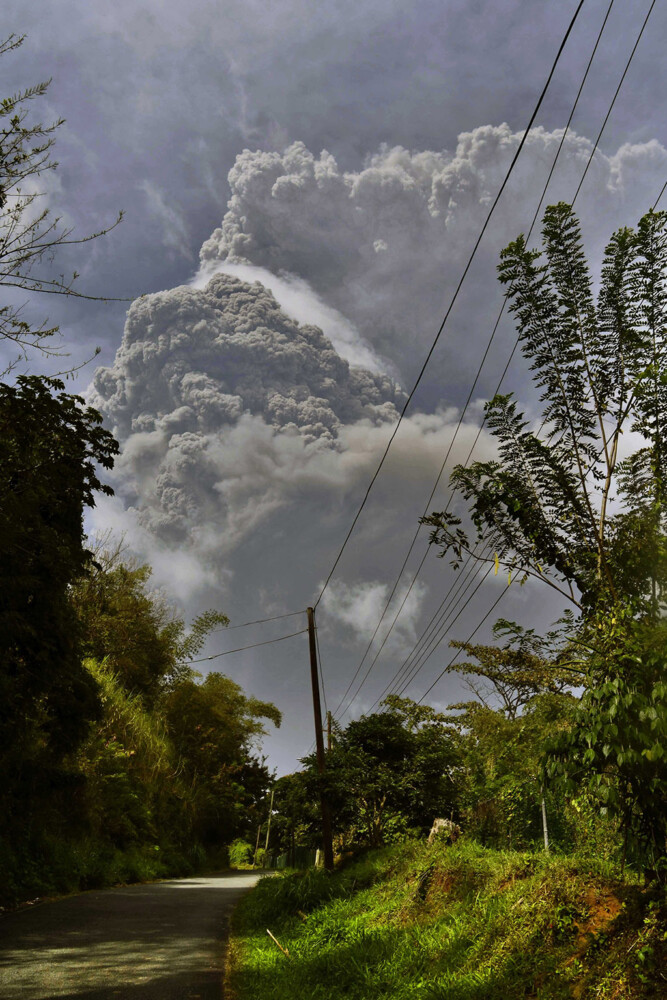 Plumes of ash rise from the La Soufriere volcano as it erupts on the eastern Caribbean island of St. Vincent, as seen from Chateaubelair, Friday, April 9, 2021. (AP Photo/Orvil Samuel)