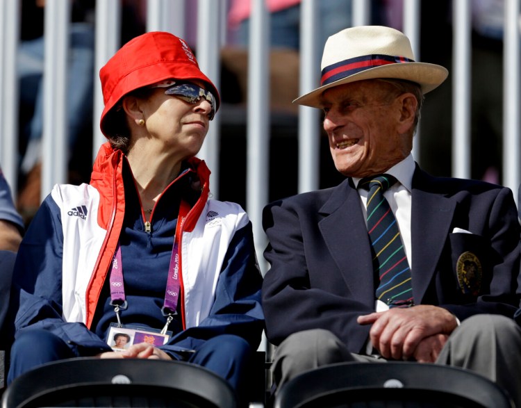 FILE - In this Sunday, July 29, 2012 file photo, Princess Anne, left, attends the equestrian eventing dressage phase with her father Prince Phillip the Duke of Edinburgh, husband of Britain's Queen Elizabeth II, at the 2012 Summer Olympics, in London. In a message released by Buckingham Palace on Sunday, April 11, 2021, Anne praised Philip’s “ability to treat every person as an individual in their own right with their own skills," a nod to the many charities and other organizations he was involved with. Prince Philip died on Friday, April 9, 2021. He was 99. (AP Photo/David Goldman, FIle)