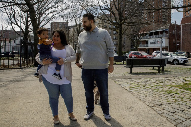 Priscilla Medina stands with her husband, Jason Sanchez, and her son in the Rego Park neighborhood of Queens in New York on Wednesday, April 7, 2021. If Medina had gotten COVID-19 a year earlier, she would have had no treatments proven safe and effective to try. But when the 30-year-old nurse arrived at a Long Island hospital in March 2021, so short of breath she could barely talk, doctors knew just what to do. They quickly arranged for her to get a novel drug that supplies virus-blocking antibodies, and “by the next day I was able to get up and move around,” she said. After two days, “I really started turning the corner. I was showering, eating, playing with my son.” (AP Photo/Marshall Ritzel)
