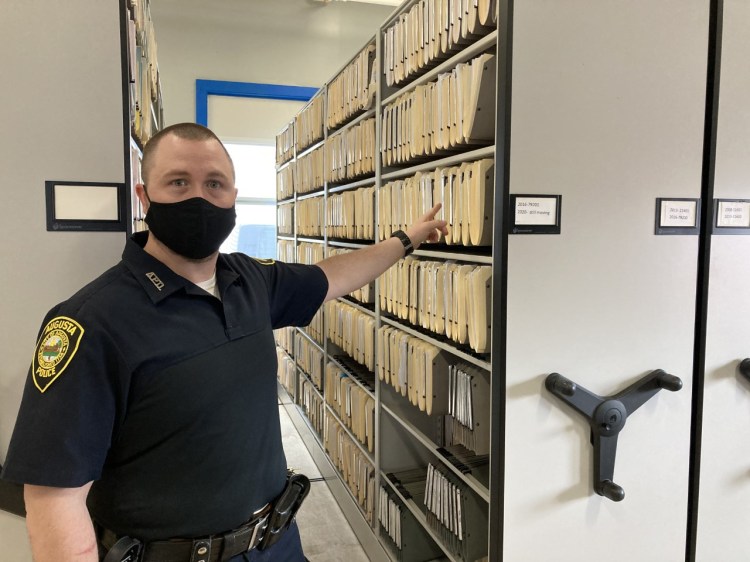Christopher Hutchings, court officer for the Augusta Police Department,  shows the large filing system the department uses to store information and important files.