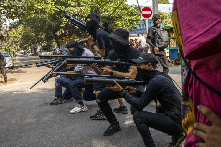 Anti-coup protesters line in formation with homemade air rifles during a demonstration against the military in Yangon, Myanmar, on Saturday.

