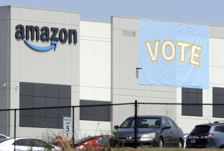 Abanner encouraging workers to vote in labor balloting is shown March 30 at an Amazon warehouse in Bessemer, Ala.

