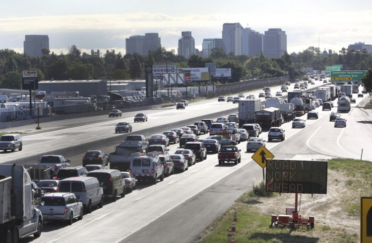 In this April 22, 2014 file photo, drivers enter Sacramento on Highway 50 to come to a near stand still as traffic backs up in West Sacramento, Calif. The U.S. Transportation Department is moving to reverse former President Donald Trump's bid to end California's ability to set its own automobile tailpipe pollution standards.
