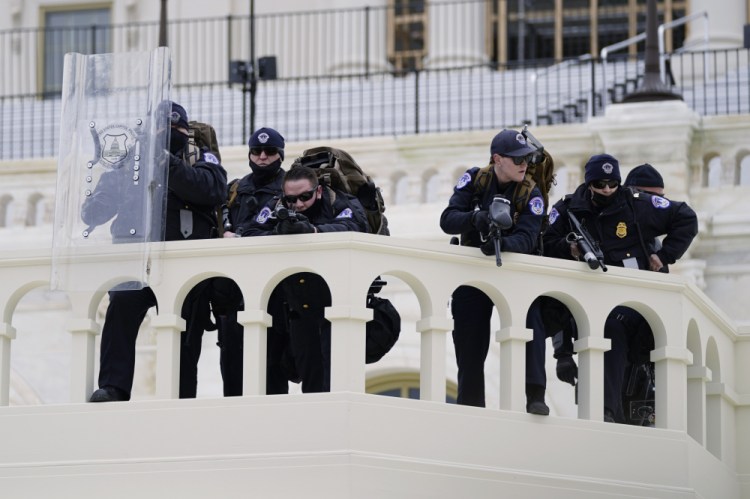 Police keep a watch on demonstrators before they broke through a police barrier at the Capitol in Washington on Jan. 6. A blistering internal report by the U.S. Capitol Police describes a multitude of missteps that left the force unprepared for the insurrection that day.