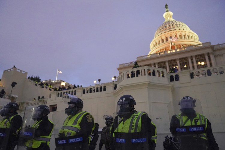 Police form a line to guard the U.S. Capitol after violent rioters stormed it on Jan. 6. 