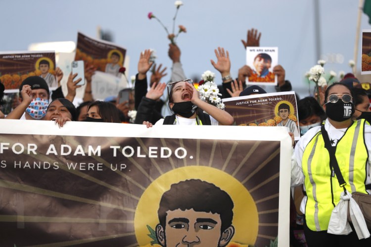 Demonstrators attend a peace walk honoring the life of police shooting victim 13-year-old Adam Toledo on Sunday in Chicago's Little Village neighborhood. The Justice Department hasn’t said yet whether it will look into the case. 