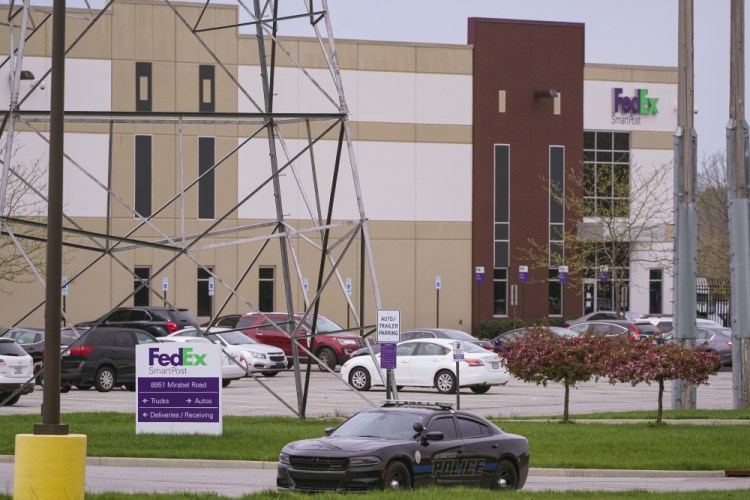 A sheriff's car blocks the entrance to the FedEx facility in Indianapolis, Saturday, where eight people were killed during a shooting late Thursday night. 