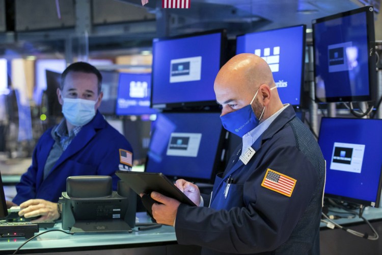 Trader Fred DeMarco, right, works on the floor of the New York Stock Exchange on Thursday.