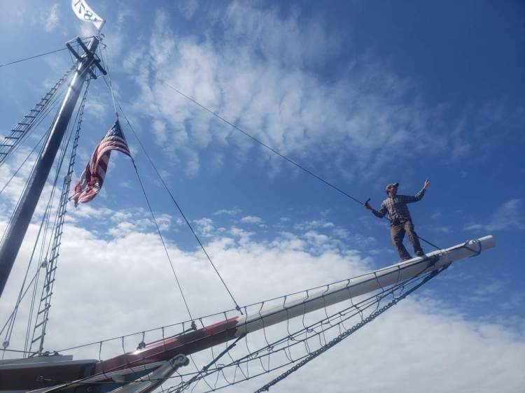Capt. Garth Wells balances on the bowsprit of the schooner Lewis R. French just before the 150-year-old vessel was launched Wednesday back into the waters at North End Shipyard.