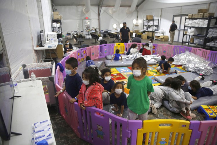 Young unaccompanied migrants, from ages 3 to 9, watch television inside a playpen March 30 at the U.S. Customs and Border Protection facility, the main detention center for unaccompanied children in the Rio Grande Valley, in Donna, Texas.