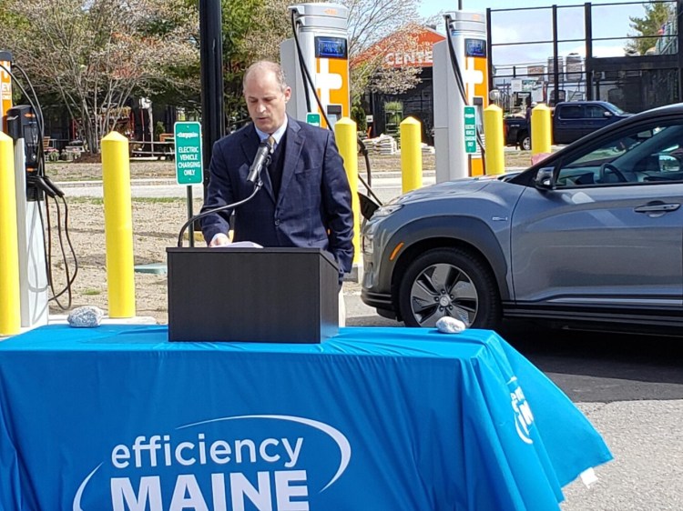 Michael Stoddard, executive director of Efficiency Maine, speaks during a ceremony Monday at a new electric vehicle charging station at the Hannaford supermarket in North Windham. The station is part of a new network of public charging stations meant to help encourage a transition to electric vehicles.