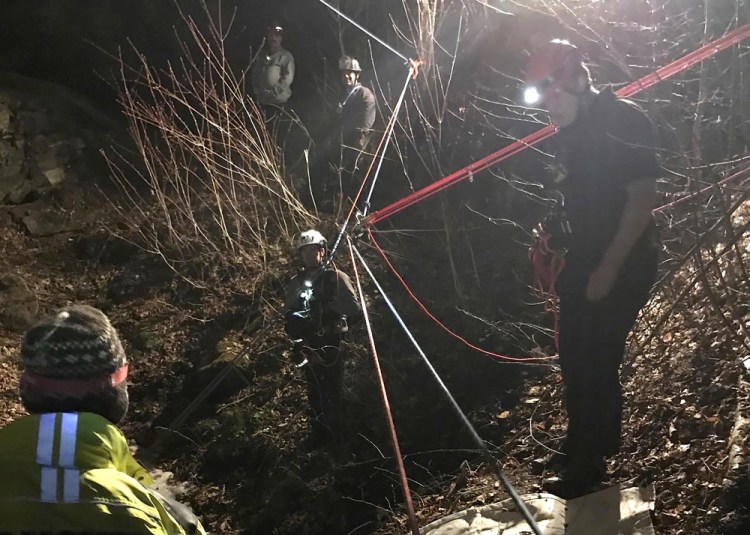 In this photo provided by first responders, rescue crews from Vermont and New Hampshire use a series of ropes and pulleys while working to rescue a man from an abandoned copper mine, late Saturday, in Corinth, Vermont. (Courtesy Hanover Fire Department via AP)