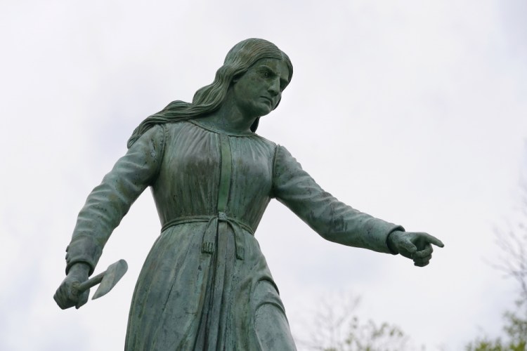 A statue of Hannah Duston, dated 1879, stands in the Grand Army of the Republic Park in Haverhill, Mass., meant to honor the English colonist who, legend has it, slaughtered her Native American captors after the gruesome killing of her baby. (AP Photo/Steven Senne)