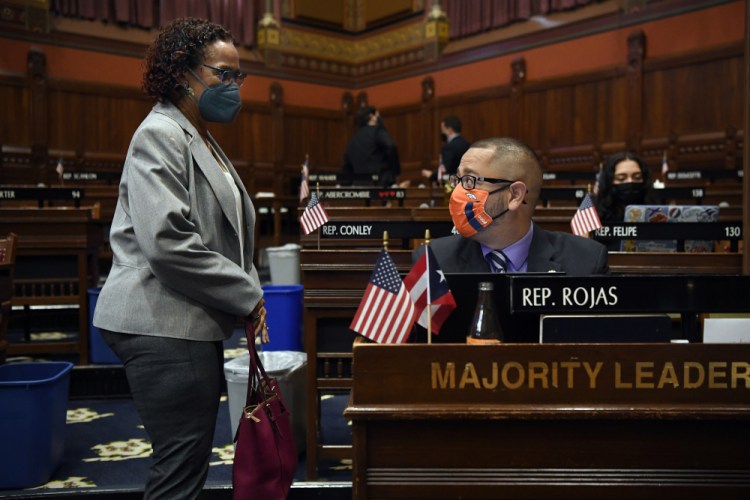 Connecticut House Majority Leader Jason Rojas, D-East Hartford, right, speaks with State Rep. Toni Walker, D-New Haven, during session at the State Capitol in Hartford, Conn. Rojas was the first person of color in the state to hold one of the top jobs in the General Assembly. 