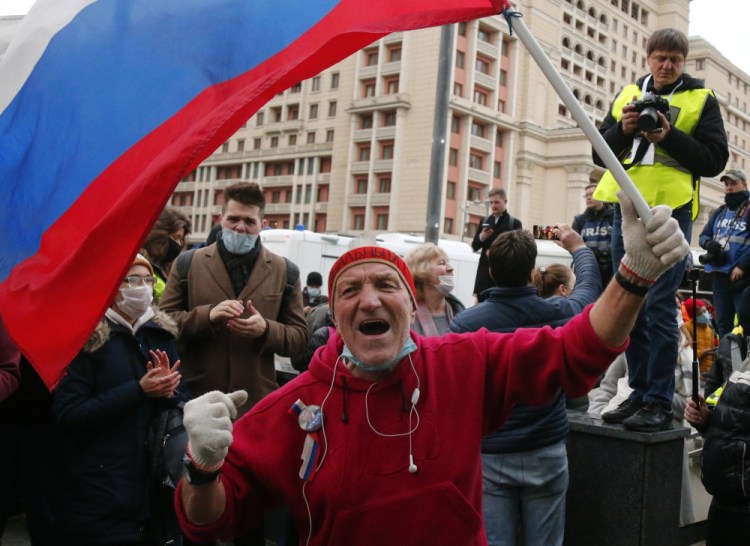 A supporter waves a Russian flag and shouts slogans during the opposition rally in support of jailed opposition leader Alexei Navalny in Moscow on Wednesday.