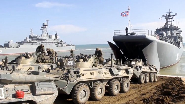 This handout photo taken from a video released on Friday by Russian Defense Ministry Press Service shows Russian military armored vehicles roll into landing vessels after drills in Crimea. Russian Defense Minister Sergei Shoigu on Thursday ordered troops back to their permanent bases after a massive military buildup that caused Ukrainian and Western concerns. 