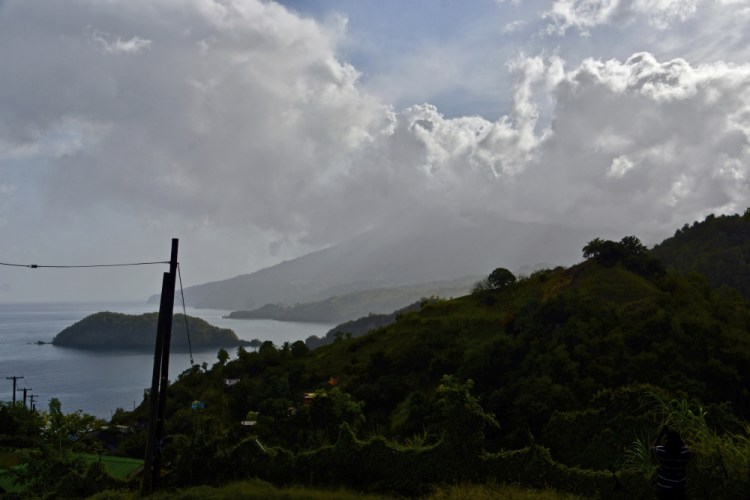 Ash rises into the air as La Soufriere volcano erupts on the eastern Caribbean island of St. Vincent, seen from Chateaubelair on Friday.

