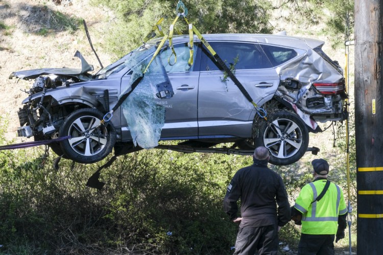 A crane is used to lift a vehicle following a rollover accident involving golfer Tiger Woods in the Rancho Palos Verdes suburb of Los Angeles on Feb. 23.  