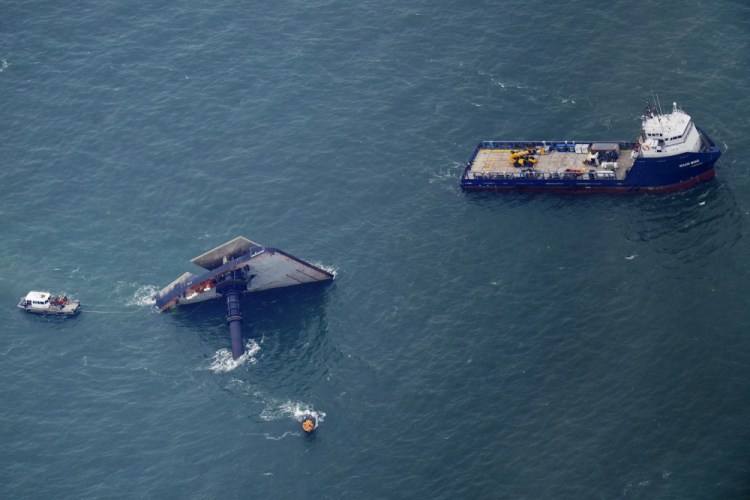 Rescue boats are seen next to the capsized lift boat Seacor Power seven miles off the coast of Louisiana in the Gulf of Mexico Sunday. The vessel capsized during a storm on Tuesday.