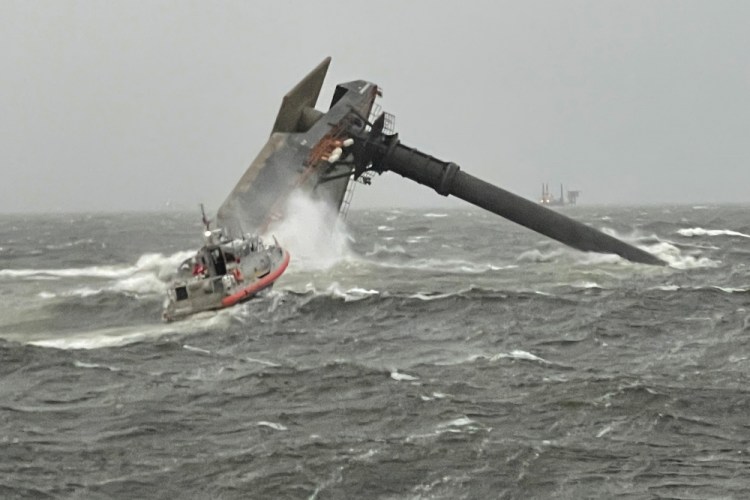 A Coast Guard Station Grand Isle response boat heads toward a capsized 175-foot commercial lift boat Tuesday, April 13, searching for people in the water 8 miles south of Grand Isle, Louisiana. 