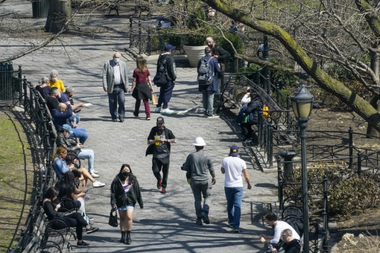 People spend lunch hour in Union Square in New York last month. Nearly half of new coronavirus infections nationwide are in just five states, including New York. 