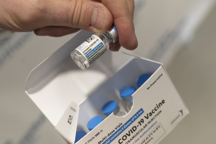 A pharmacist holds a vial of the Johnson & Johnson COVID-19 vaccine at a hospital in Bay Shore, N.Y.