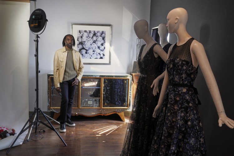 Fashion designer Kevan Hall pauses for a picture with his "Galaxy Collection" at his haute couture atelier in West Los Angeles on Thursday. A year ago, Hall quickly moved away from his trademark gowns and cocktail dresses to caftans, tunics and pull-on pants. Now Hall is adding back some dressier looks, but he’s eliminating the full skirts and scaling back the beading in favor of simple gowns and dresses in knit and tulle fabrics.